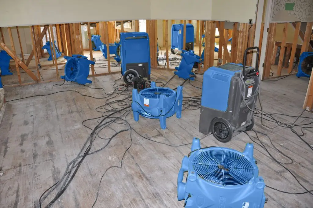 Air movers drying a gutted Spokane room after major water damage